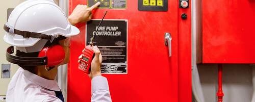 An inspector looks at a fire pump